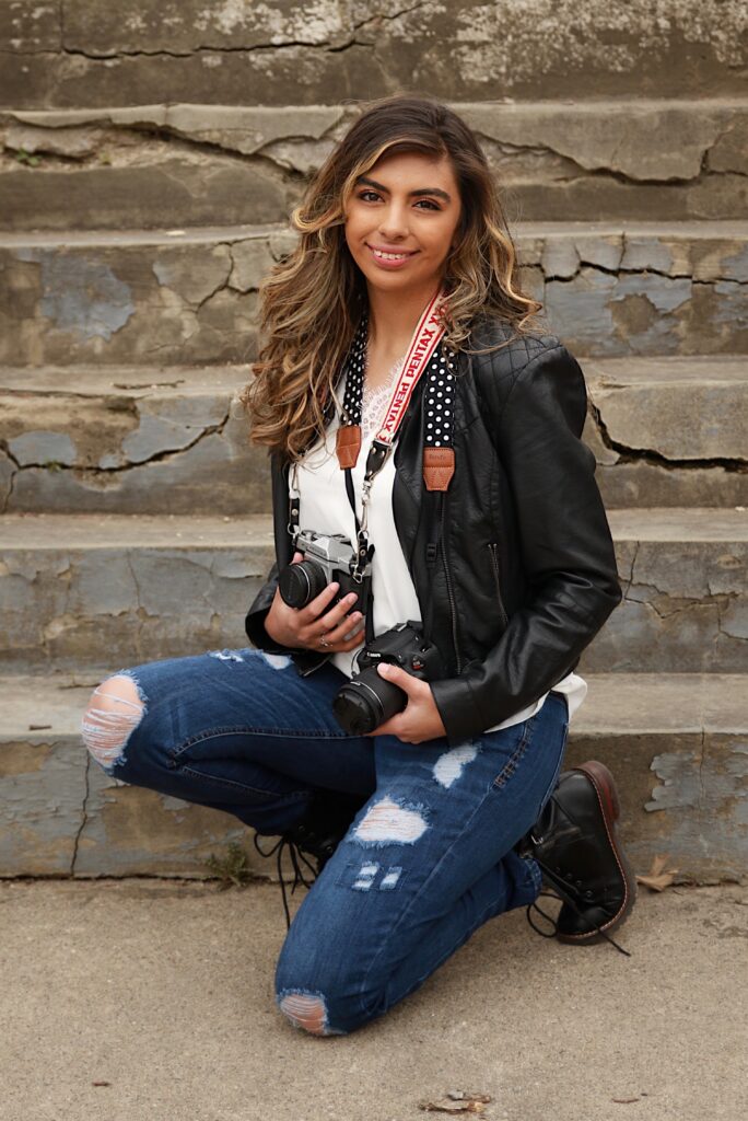 Cassie posing with her camera's to display her passion for photography