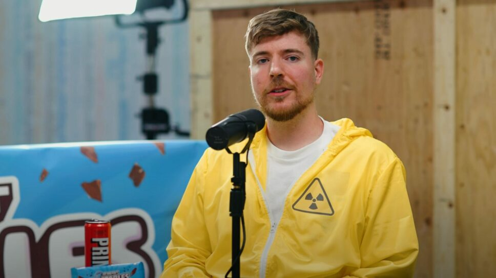 MrBeast sitting in Colin and Samir's podcast set in a yellow hazard jacket.