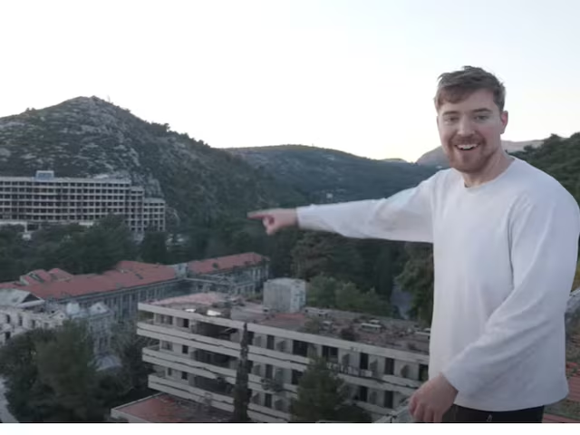 MrBeast pointing out to the abandoned city he's exploring.