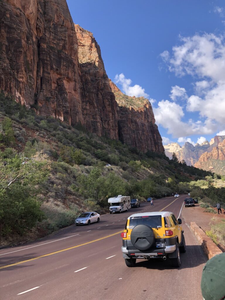 A photo of a yellow car at Zion national park.